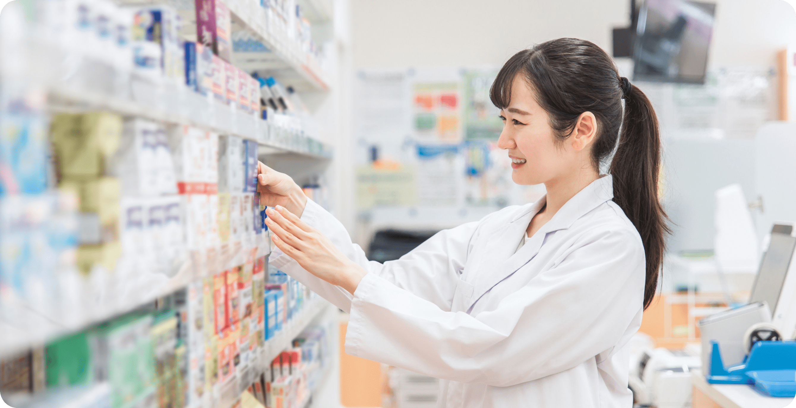 女性薬剤師が薬棚から薬を取っている様子